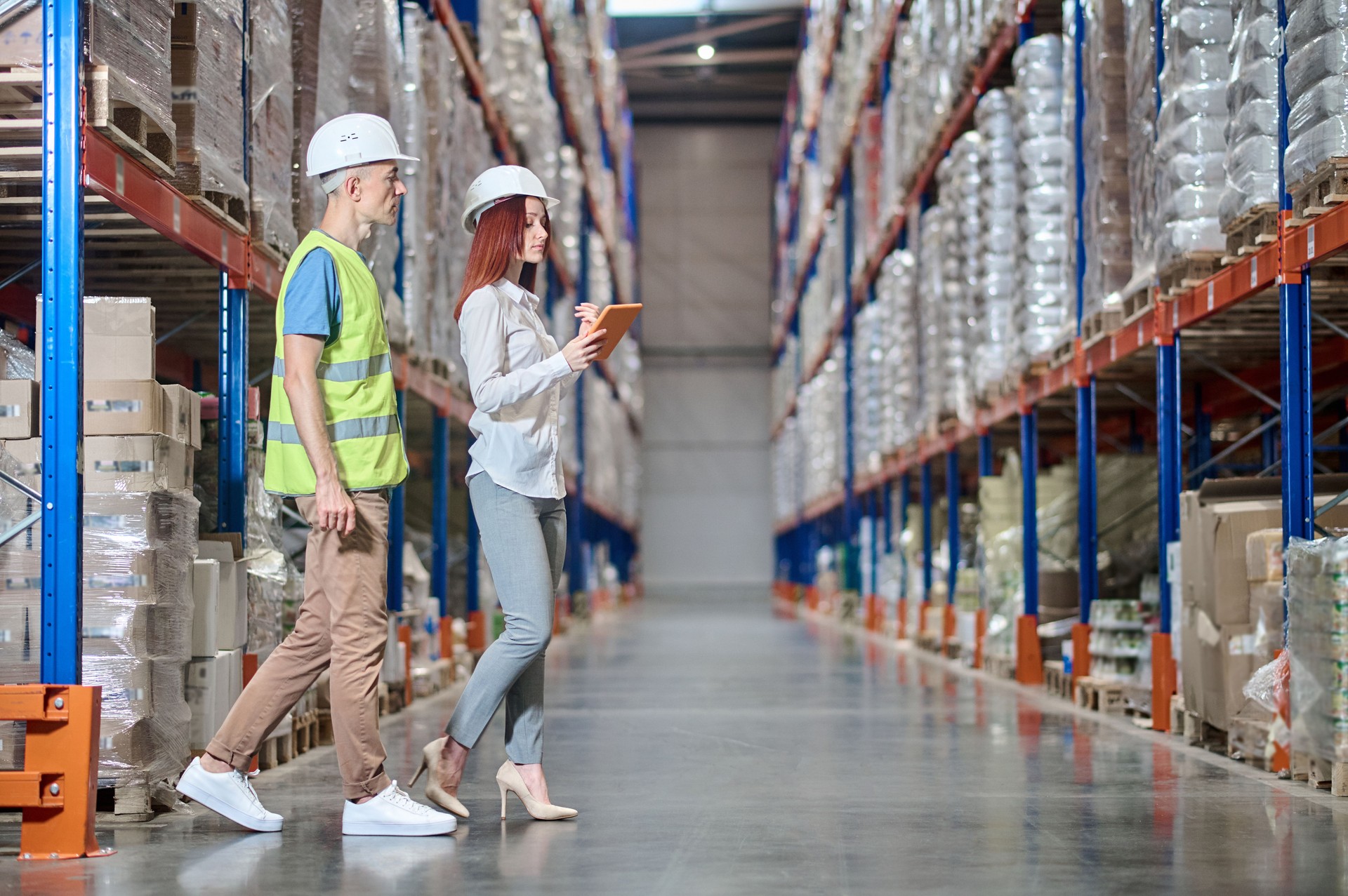 Warehouse employee and an inspector conducting a racking system inspection